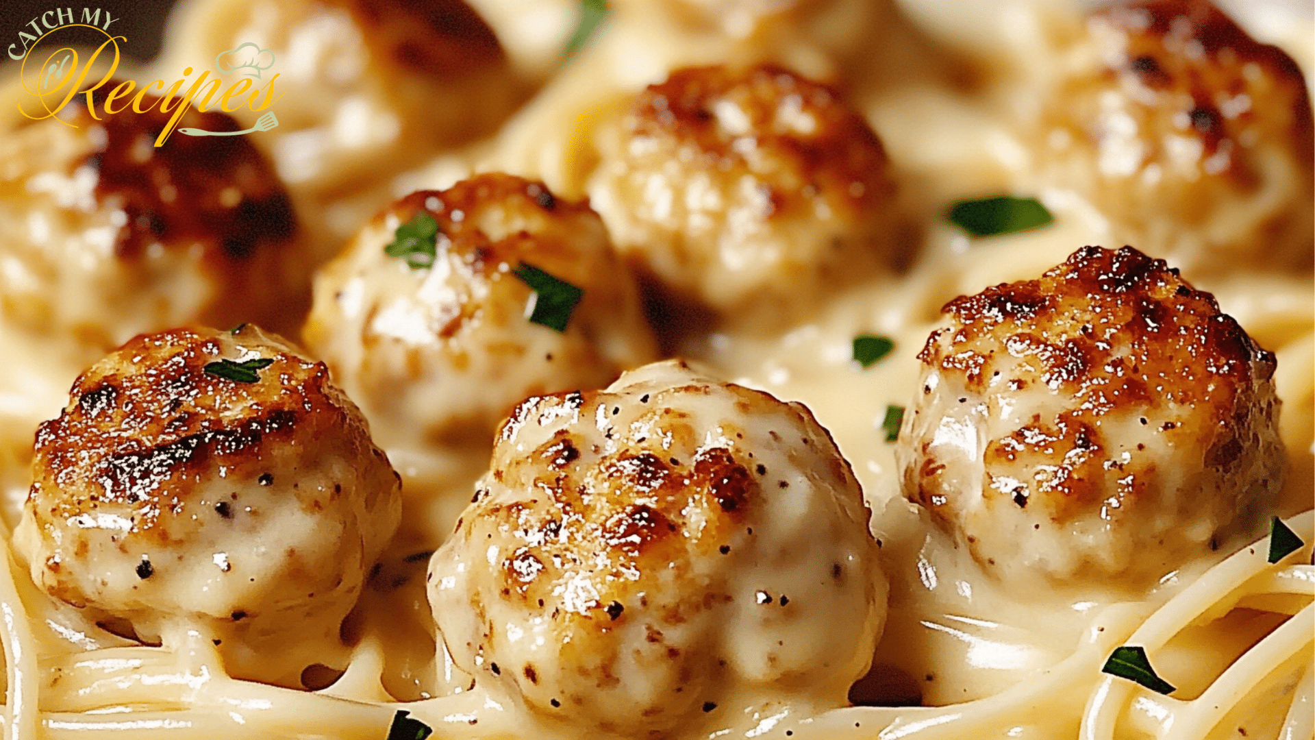 Creamy pasta dish with chicken bites and fresh parsley on a bed of spaghetti.